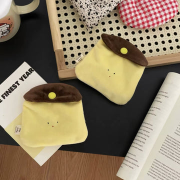Front view of the Kawaii Caramel Pudding Earphone Bag showcasing its plush design and cute pudding motif