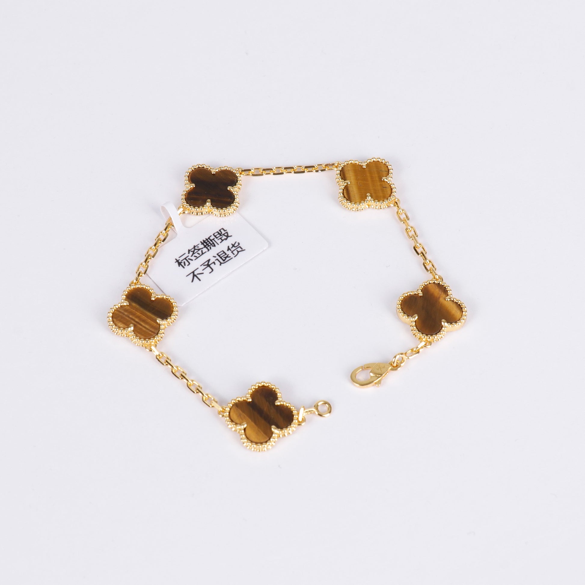 Four-leaf clover bracelet featuring tiger eye charm and gold plating