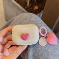 Stylish pink AirPods cover with heart charm keyring
