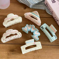 Close-up of heart claw clip showcasing pastel detailing and glossy acrylic finish