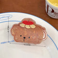 Mouse-shaped acrylic clip with a red scarf and pastel details, styled for winter or cozy outfits