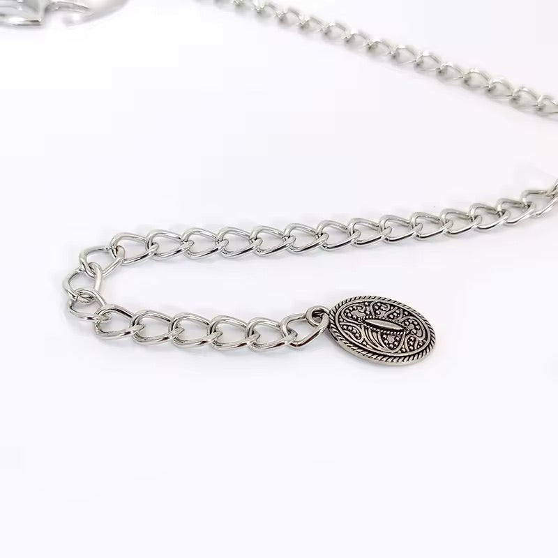 Y2K silver waist chain styled over black dress