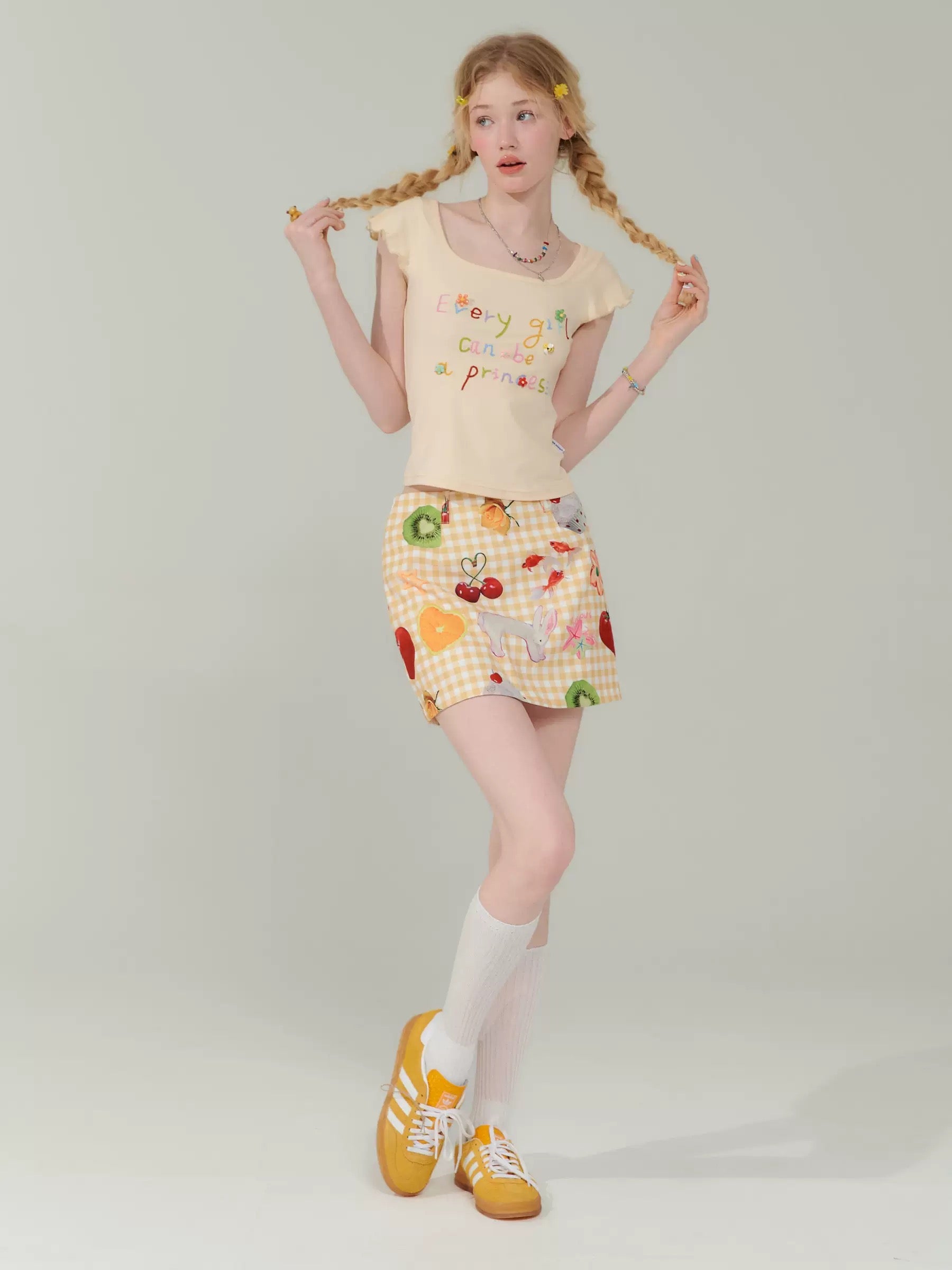 Cute preppy plaid skirt with a pastel fruit design, perfect for retro outfits