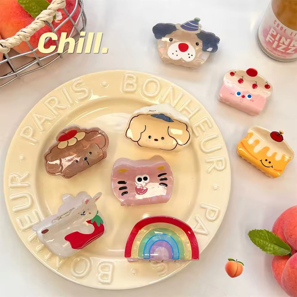 The cake slice clip placed beside notebooks and pens, styled for school girl aesthetics