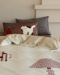 Children's bedding set with animal patterns on a bed