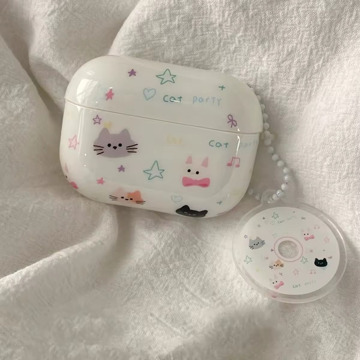 Close-up of cat earphone case with charm