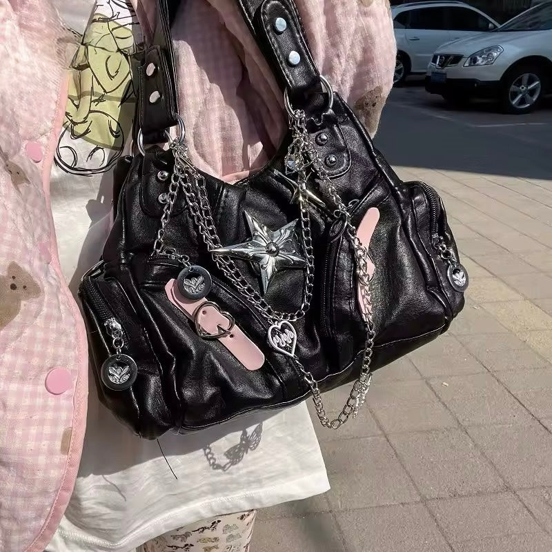 Edgy black leather tote with chunky silver chain straps