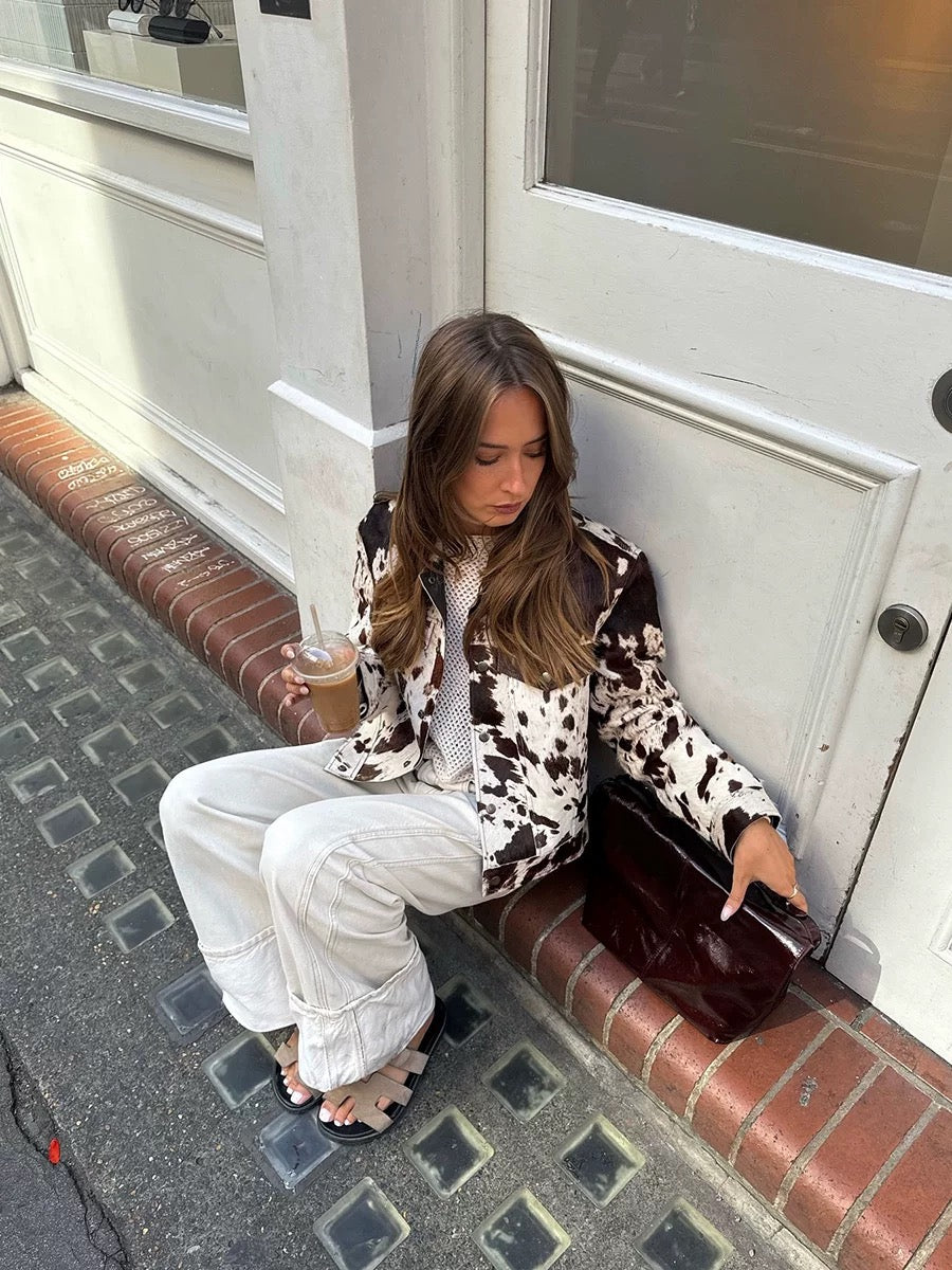 Statement cow pattern coat featuring long sleeves, wool blend fabric, and cropped silhouette for bold autumn layering