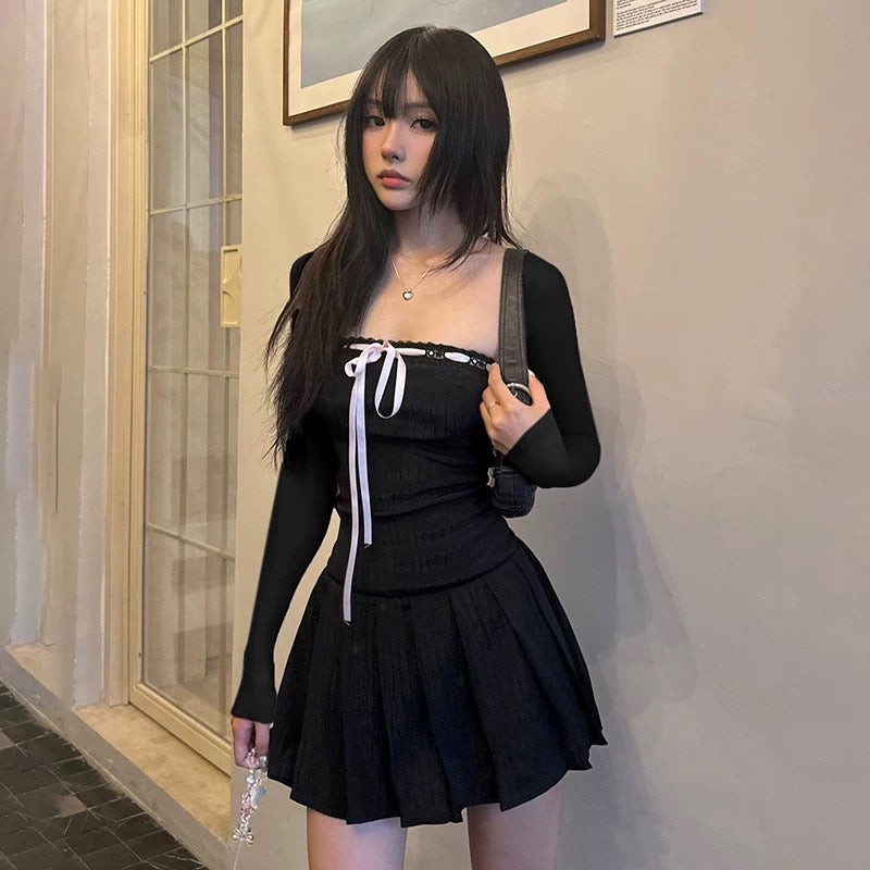 Balletcore-inspired black mini dress featuring a pleated skirt and bows
