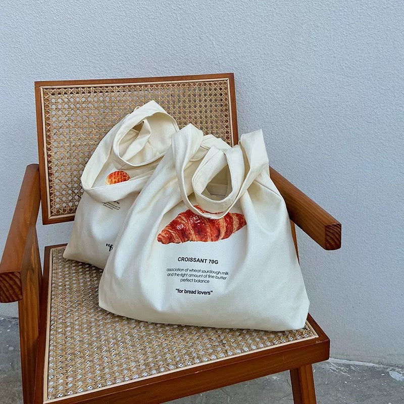 Overhead shot displaying the bag's capacity with books and groceries inside.