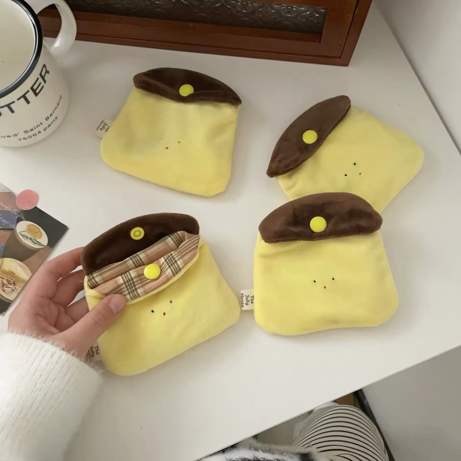 The earphone bag placed next to common items for size comparison