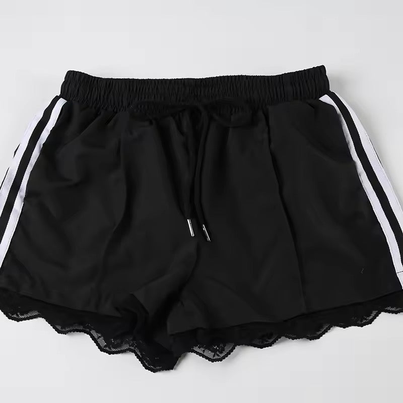 Black sporty Y2K shorts with side stripes and lace trim on the hem