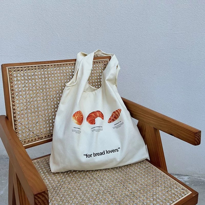 Front view of the Croissant Canvas Tote Bag showcasing the bread illustration.