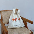 Side angle highlighting the spacious interior of the canvas tote.