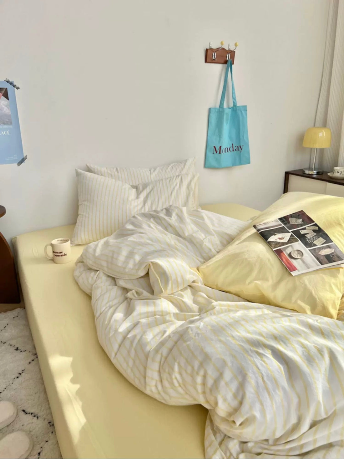 Bedroom with a yellow bedspread, white pillows, and a white comforter.