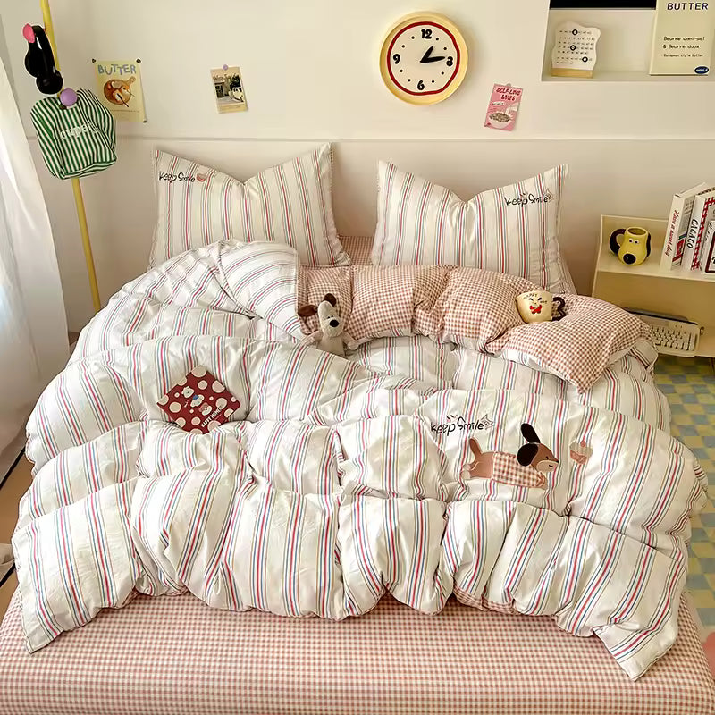 Striped bedding with cartoon characters on a bed in a room with a clock and decor items.