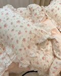 Floral patterned comforter with ruffles on a bed