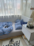 Small bedroom with a bed, nightstand, and window with blinds.