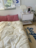 Bedroom with a bed, nightstand, and rug with text