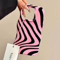 Close-up of the black and pink stripes merging in a wave design on the iPhone case.