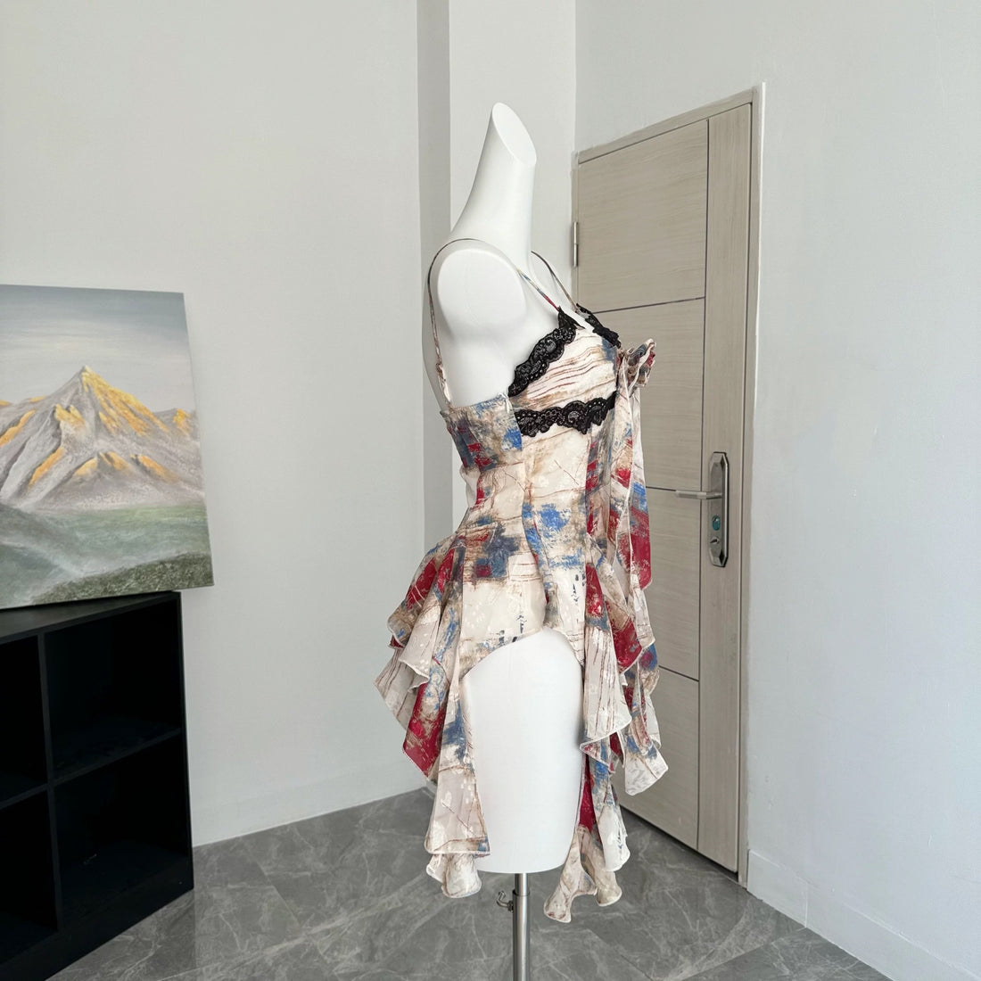 Y2K-inspired vintage gyaru crop top with lace ruffle trim and halter neck, featuring irregular hem and soft oil painting print