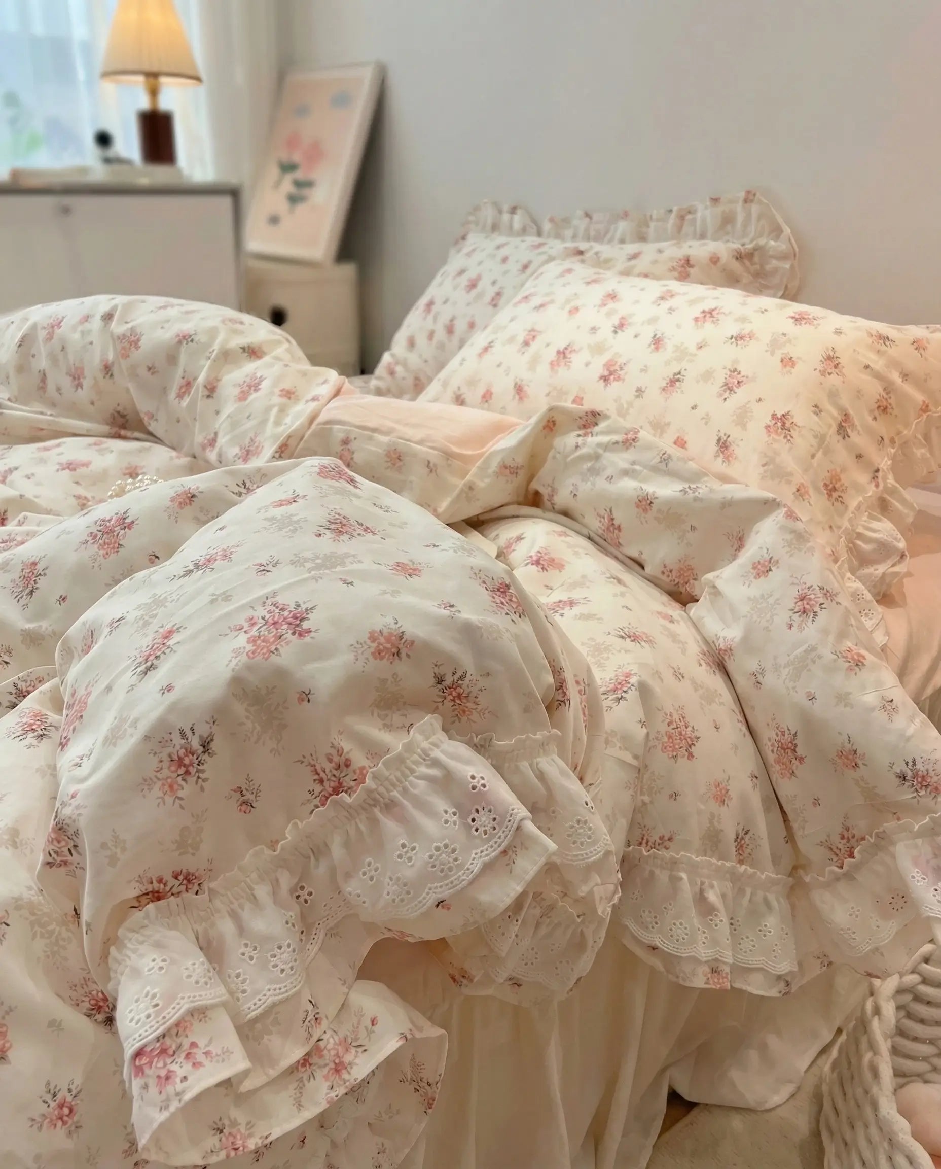 Floral patterned bedding set on a bed in a bedroom setting.