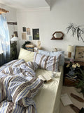 Cozy bedroom with striped bedding and decor