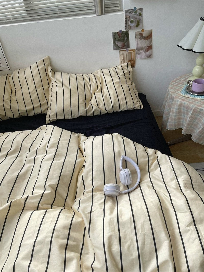 Bed with striped bedding in a bedroom setting