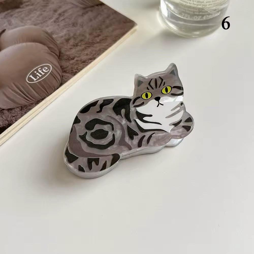 The orange tabby acetate cat hairpin with white detailing, perfect for preppy or school girl fashion