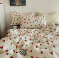 Bedding set with red heart patterns on a white background
