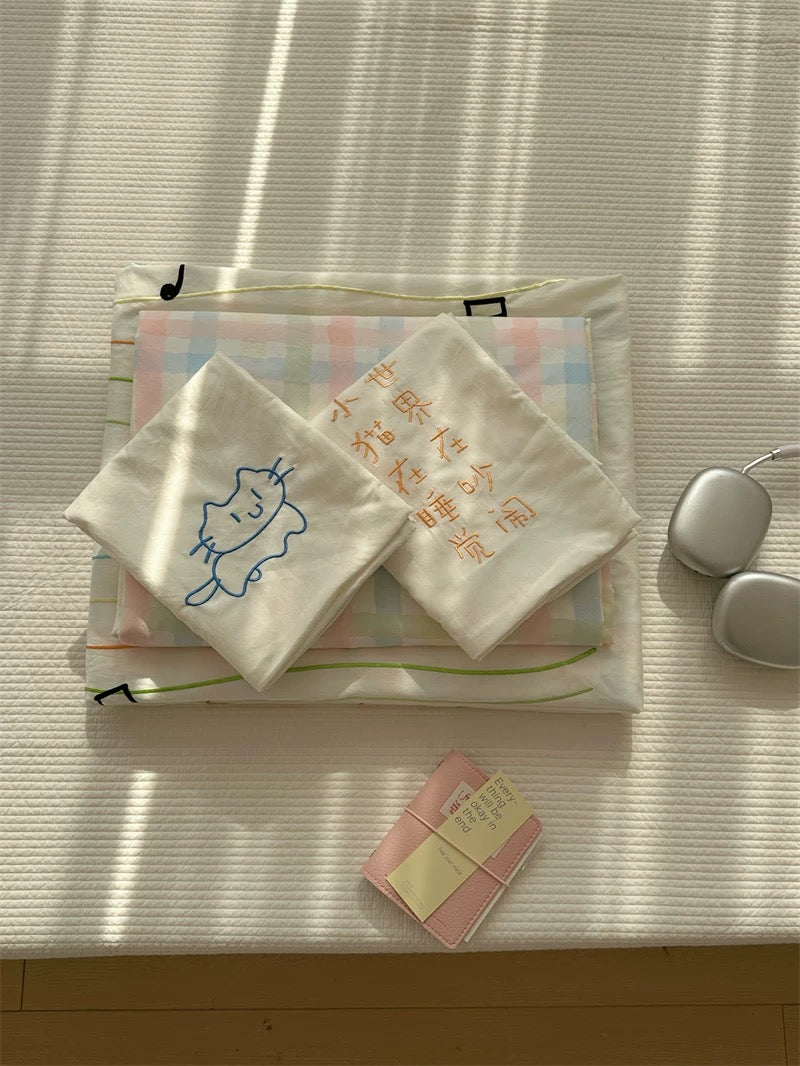 Stack of folded towels with cartoon designs on a textured surface