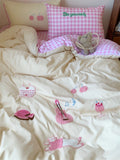 Bed with pink checkered pillow and decorative elements on a light background