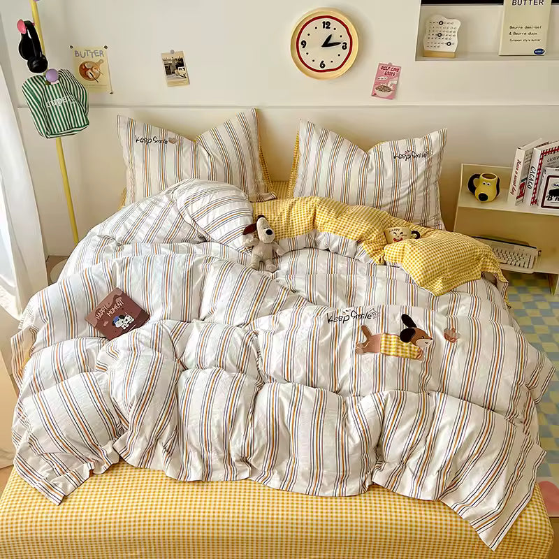 Striped bedding with cartoon characters on a bed in a room with a clock and decor items.