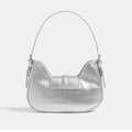 Crescent mini handbag in Y2K silvery pink, inspired by 2000s punk and biker trends with a detachable strap and fashionable silhouette