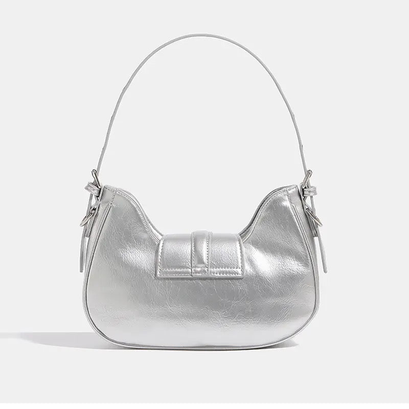 Crescent mini handbag in Y2K silvery pink, inspired by 2000s punk and biker trends with a detachable strap and fashionable silhouette