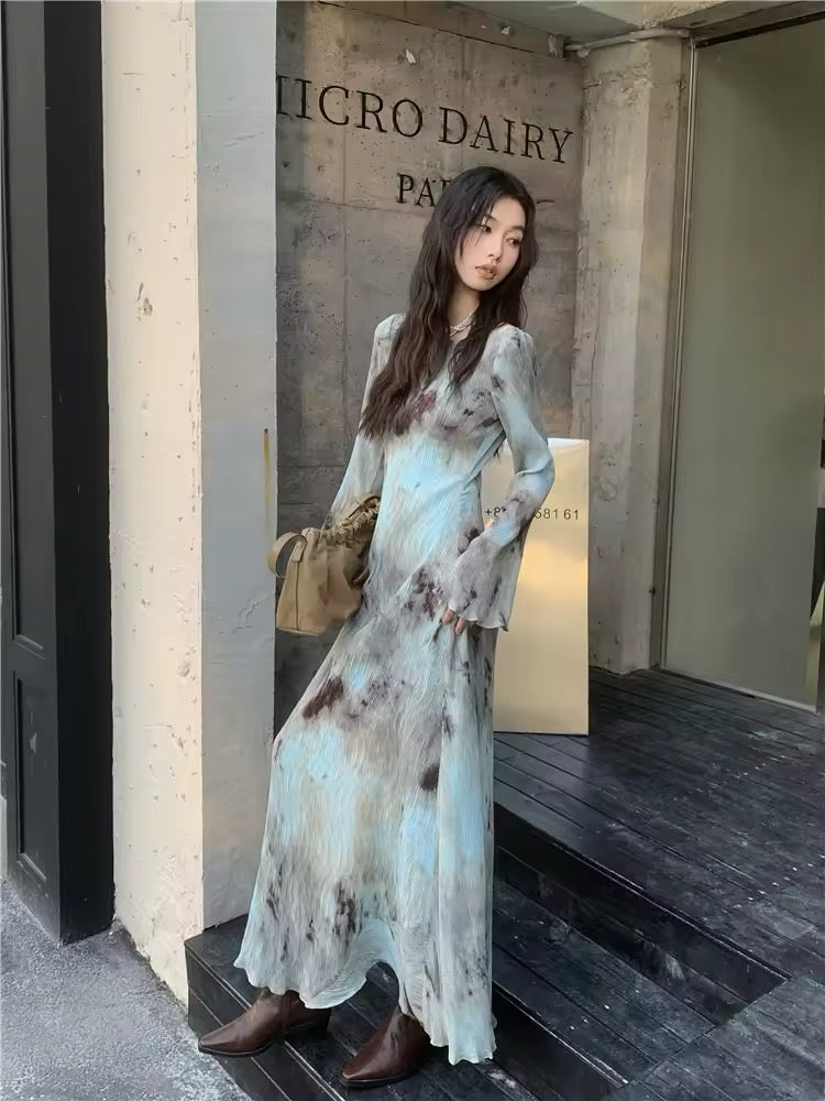 Backless design of the dress highlighting the subtle tie dye print
