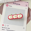 Set of pink and red fruit clips styled with a rose-themed flat lay, enhancing soft girl aesthetic