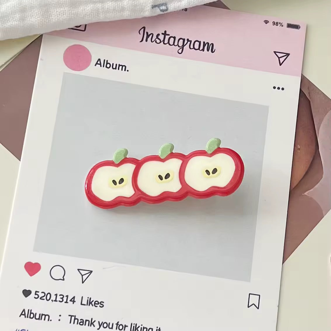 Set of pink and red fruit clips styled with a rose-themed flat lay, enhancing soft girl aesthetic