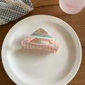 Rounded cloud-shaped crab clip in ivory with pink gingham ribbon and floral accents