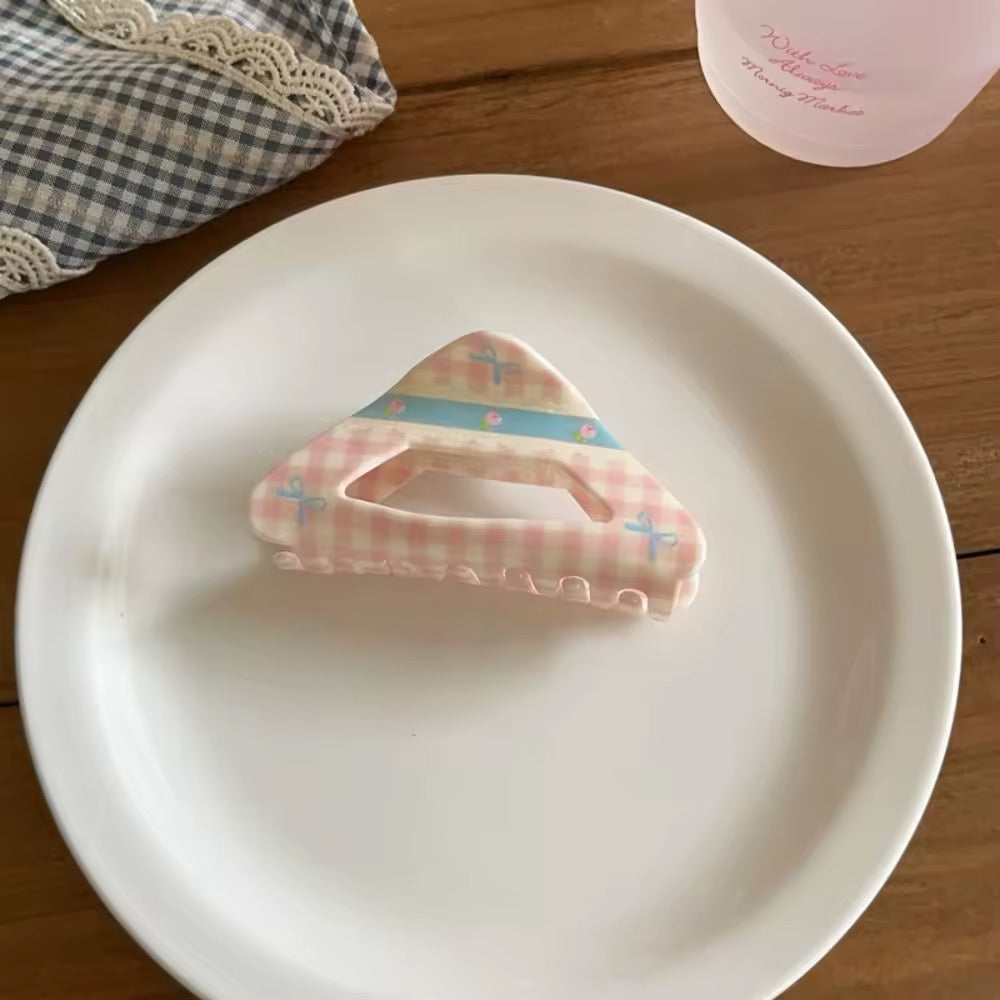 Rounded cloud-shaped crab clip in ivory with pink gingham ribbon and floral accents