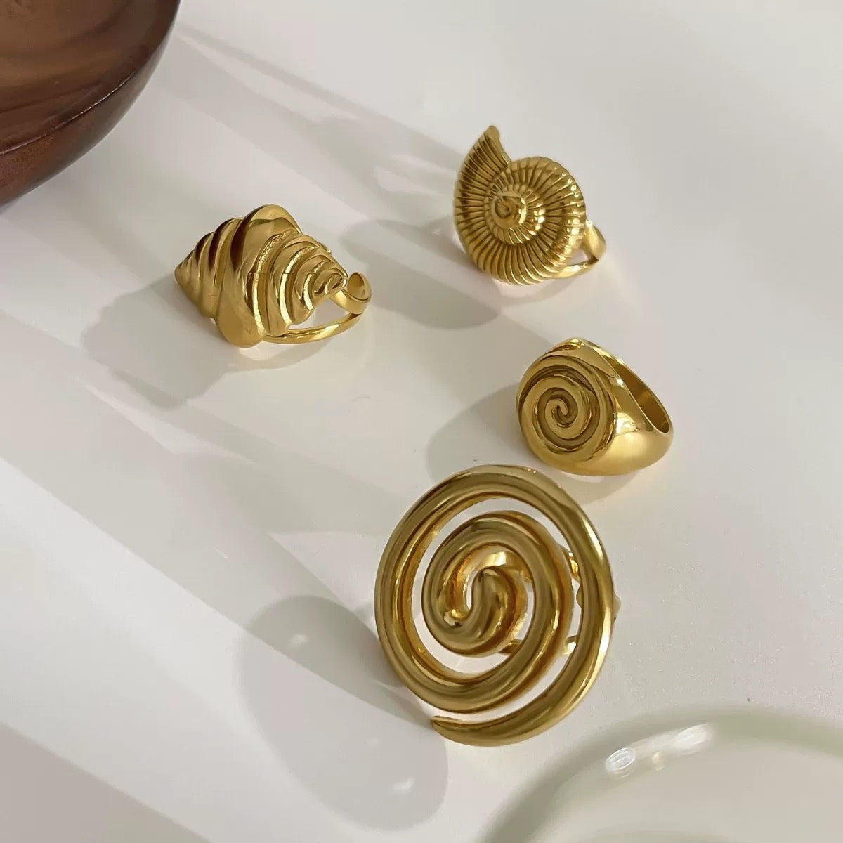 Adjustable open-ring design with a chunky spiral shell shape