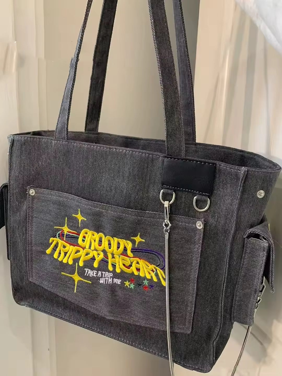 Groovy embroidery on gray canvas handbag with rings