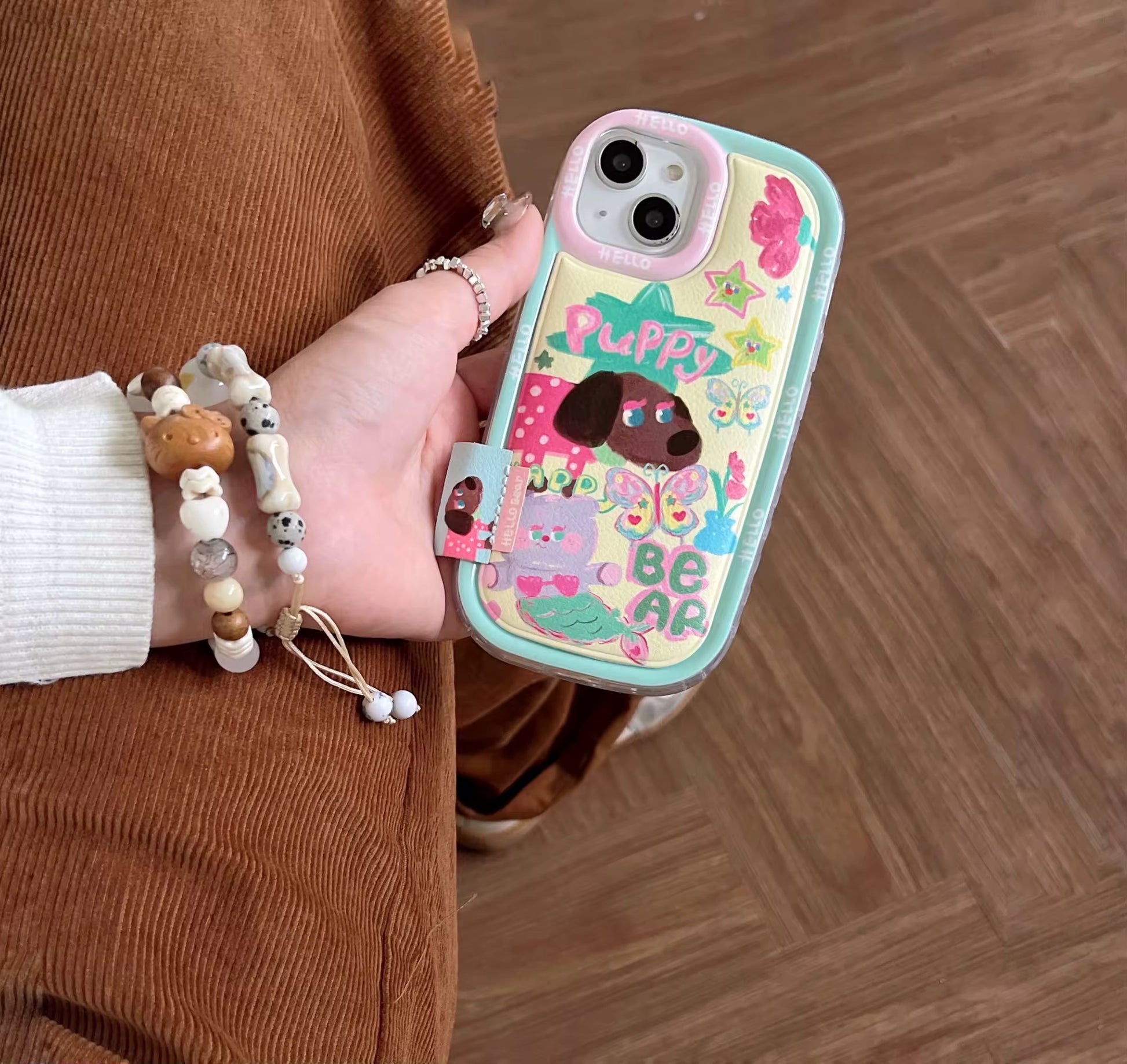 Close-up of puffy bear and puppy artwork on iPhone case