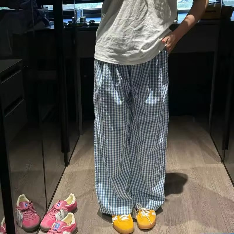 Baggy Y2K-style plaid pants captured in soft lighting for an aesthetic indoor mirror shot