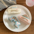 White square hair claw with pink bows and mini floral prints, adding a soft vintage vibe