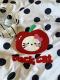 Cushion with a cartoon cat design and 'lucky cat' text on a polka dot background