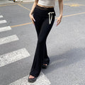 Soft girl coquette aesthetic lace-trimmed flare pants, low-waisted black leggings with bow accents, perfect for Y2K, Harajuku, and streetwear fashion