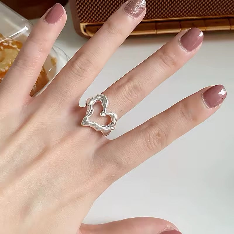Silver ring on soft girl aesthetic hand
