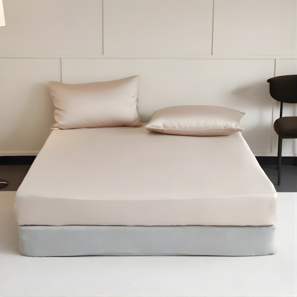 Beige mattress with two pillows on a plain background