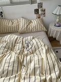 Bed with striped bedding in a bedroom setting